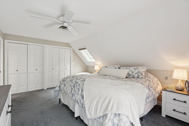 20 Wonderbrook Dr Unit 20, Kennebunk, ME 04043 - bedroom with dark carpet, two closets, lofted ceiling, a skylight, and ceiling fan