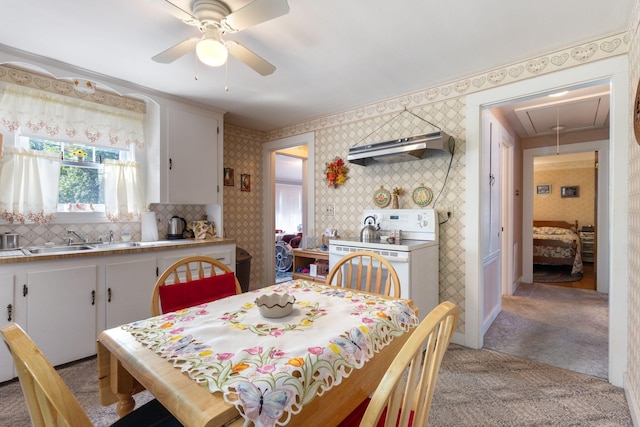 395 Alfred St, Biddeford, ME 04005 - dining area with attic access, light colored carpet, ceiling fan, and wallpapered walls