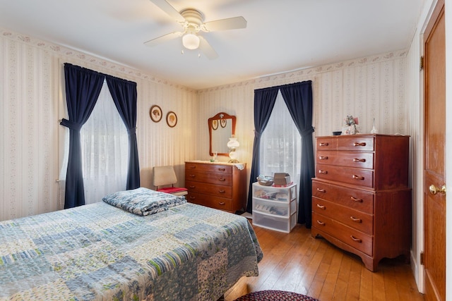 395 Alfred St, Biddeford, ME 04005 - bedroom featuring wallpapered walls, wood-type flooring, multiple windows, and ceiling fan