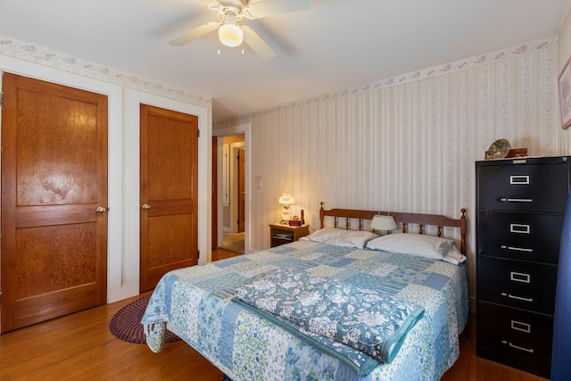 395 Alfred St, Biddeford, ME 04005 - bedroom with wood finished floors, wallpapered walls, and ceiling fan