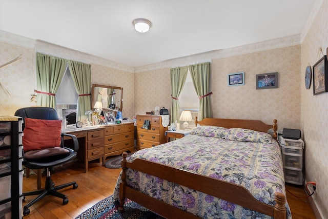 395 Alfred St, Biddeford, ME 04005 - bedroom featuring wallpapered walls, hardwood / wood-style flooring, and a desk