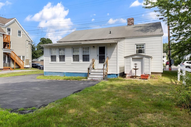 395 Alfred St, Biddeford, ME 04005 - view of front of property with entry steps, a front yard, a chimney, and a shingled roof