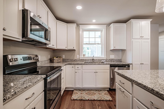 189 Falcon Crest Dr Unit 31, Gorham, ME 04038 - kitchen featuring appliances with stainless steel finishes, dark wood-style floors, white cabinets, recessed lighting, and light stone counters