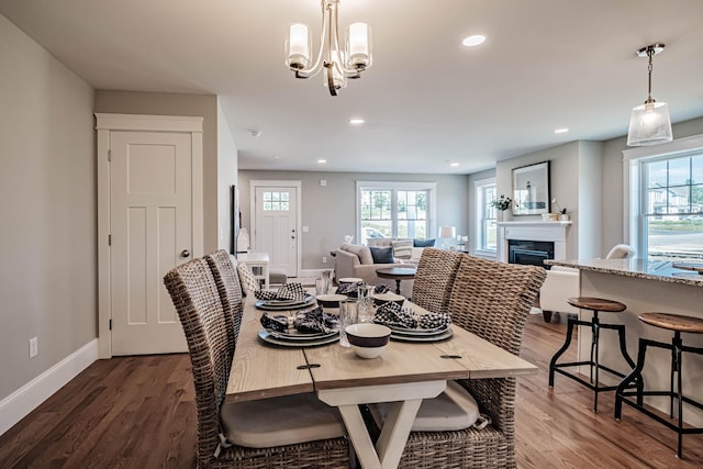 189 Falcon Crest Dr Unit 31, Gorham, ME 04038 - dining room with healthy amount of natural light, wood finished floors, a fireplace, recessed lighting, and a chandelier