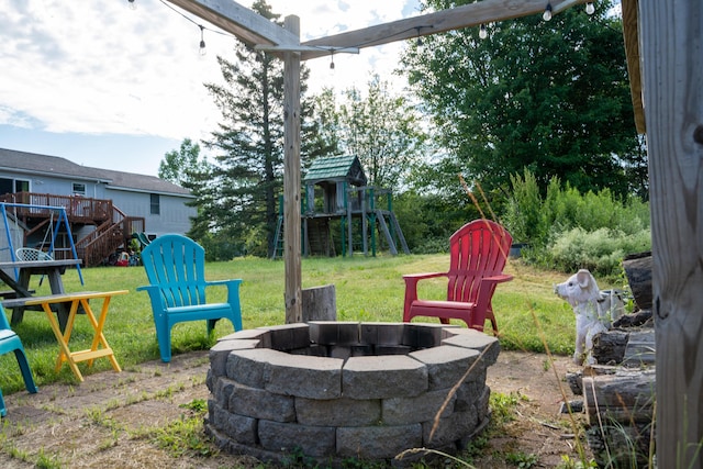 3922 Union St, Levant, ME 04456 - view of grassy yard with an outdoor fire pit, a playground, stairs, and a deck