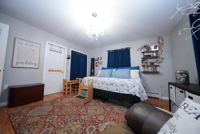 3922 Union St, Levant, ME 04456 - bedroom featuring wood finished floors, a chandelier, and a baseboard radiator