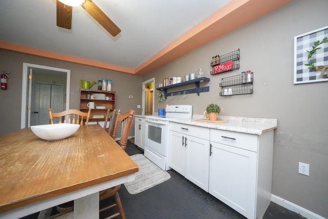 3922 Union St, Levant, ME 04456 - kitchen with electric stove, a ceiling fan, white cabinetry, open shelves, and vaulted ceiling