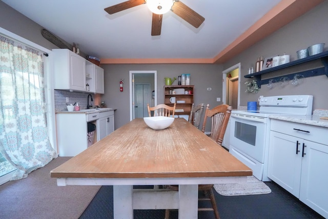 3922 Union St, Levant, ME 04456 - kitchen with open shelves, electric stove, white cabinetry, and ceiling fan