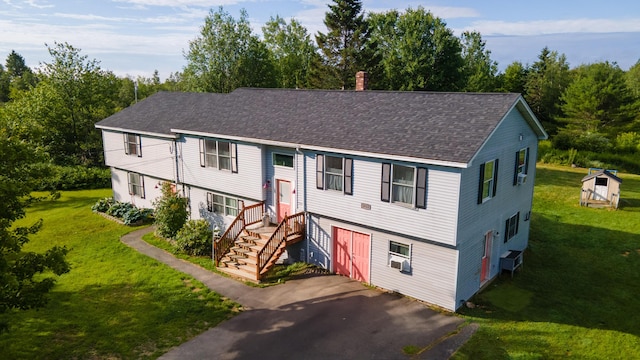 3922 Union St, Levant, ME 04456 - bi-level home with driveway, a shingled roof, an attached garage, and a front lawn
