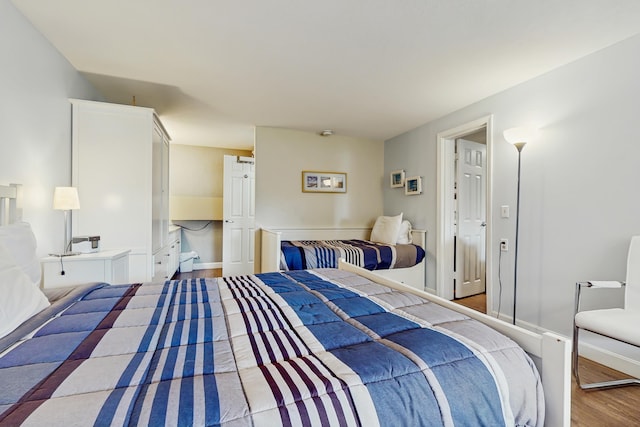 76 Post Rd Unit 17M & 18M, Wells, ME 04090 - bedroom featuring wood finished floors and baseboards