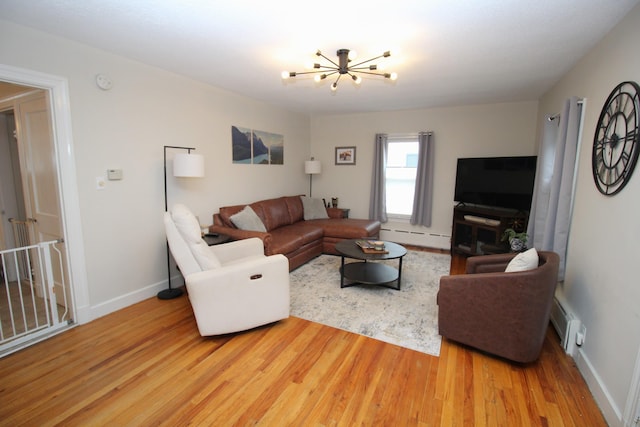 6 Shirley Ave, Lewiston, ME 04240 - living room with baseboard heating, wood finished floors, and a chandelier