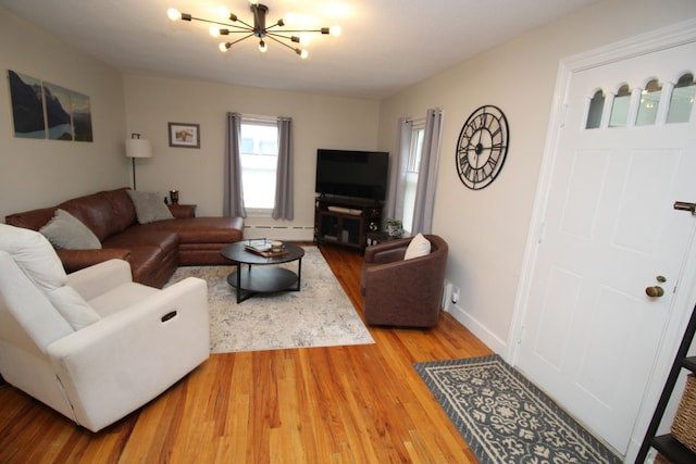 6 Shirley Ave, Lewiston, ME 04240 - living area with a chandelier, wood finished floors, and a baseboard heating unit