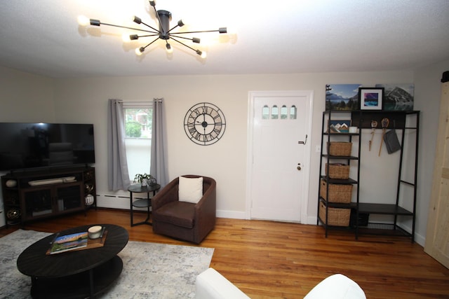 6 Shirley Ave, Lewiston, ME 04240 - living area with a chandelier, wood finished floors, and baseboard heating