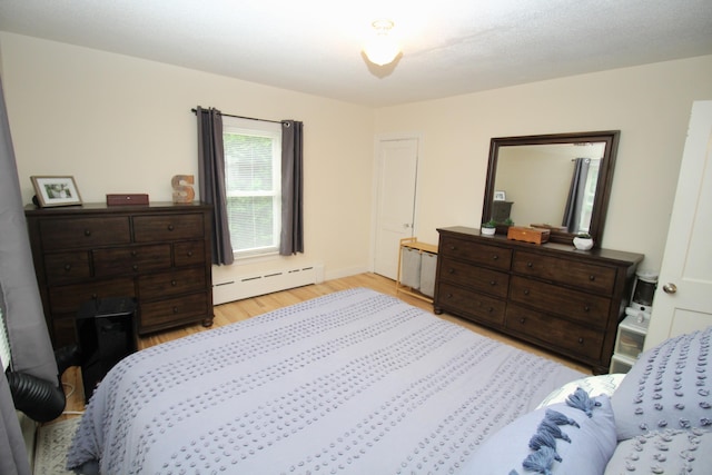 6 Shirley Ave, Lewiston, ME 04240 - bedroom featuring baseboard heating and light wood-style flooring