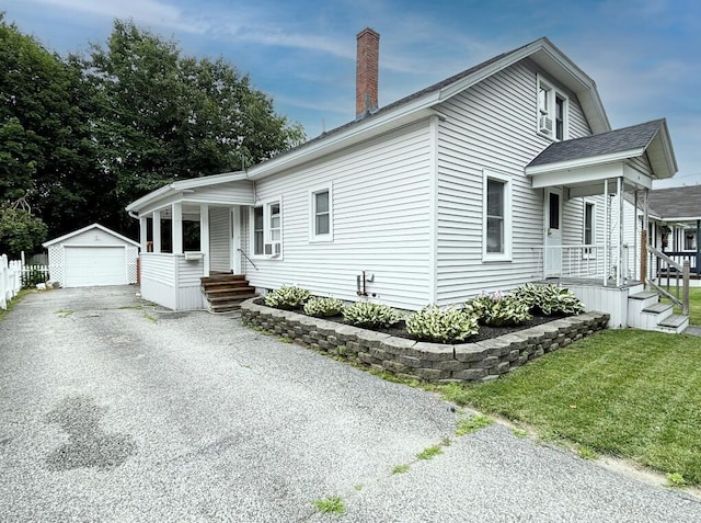 6 Shirley Ave, Lewiston, ME 04240 - view of side of home with covered porch, an outbuilding, a garage, driveway, and a chimney