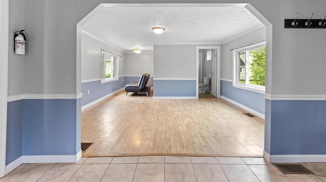 2300 Hudson Rd, Hudson, ME 04449 - unfurnished room with healthy amount of natural light, wood finished floors, crown molding, and arched walkways