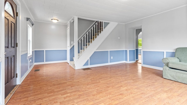 2300 Hudson Rd, Hudson, ME 04449 - entryway featuring crown molding, wood finished floors, stairs, and wainscoting
