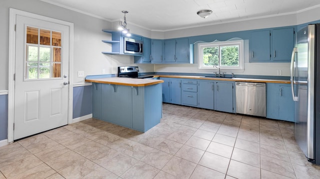2300 Hudson Rd, Hudson, ME 04449 - kitchen with appliances with stainless steel finishes, blue cabinets, a peninsula, crown molding, and light countertops