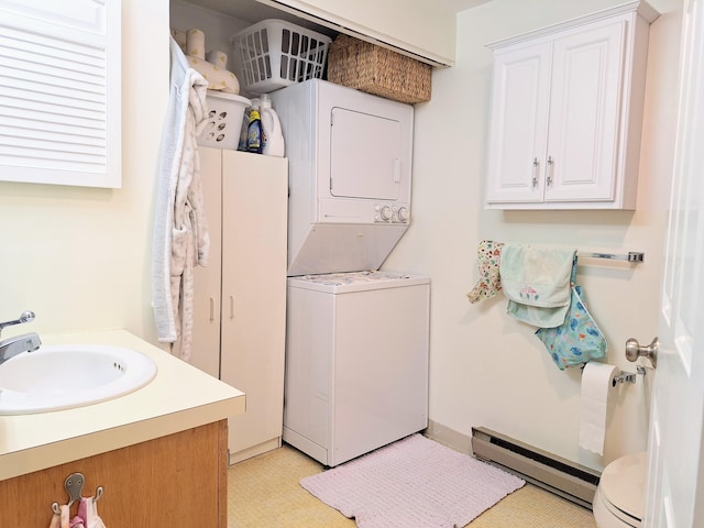 46 Glenridge Dr Unit 46, Portland, ME 04102 - laundry area with a baseboard heating unit, stacked washer / drying machine, and light flooring