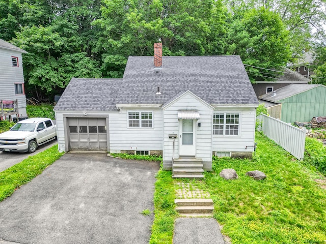 3 Gedney St, Augusta, ME 04330 - view of front of home with a chimney, asphalt driveway, a shingled roof, and an attached garage