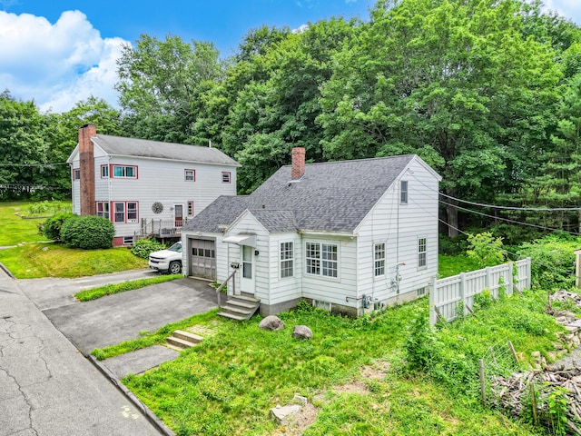 3 Gedney St, Augusta, ME 04330 - view of front facade featuring a chimney, an attached garage, a shingled roof, asphalt driveway, and entry steps