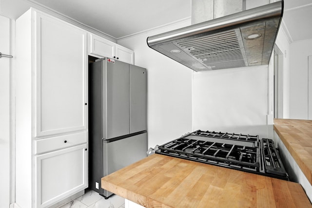 3 Gedney St, Augusta, ME 04330 - kitchen featuring freestanding refrigerator, range hood, wood counters, white cabinetry, and light marble finish flooring