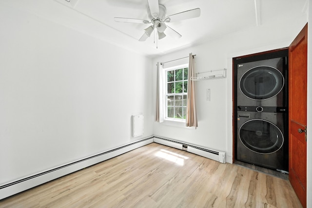 3 Gedney St, Augusta, ME 04330 - laundry area featuring stacked washing machine and dryer, light wood-style floors, a ceiling fan, and a baseboard radiator