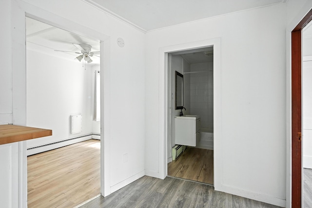 3 Gedney St, Augusta, ME 04330 - hallway with a baseboard heating unit, wood finished floors, and crown molding