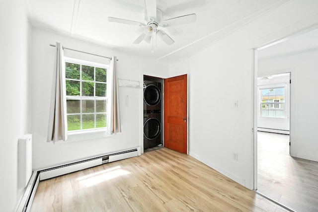 3 Gedney St, Augusta, ME 04330 - spare room featuring stacked washer / dryer, baseboard heating, healthy amount of natural light, and light wood finished floors