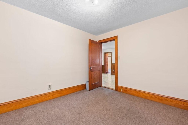 99 Hill St, Biddeford, ME 04005 - carpeted empty room with baseboards and a textured ceiling