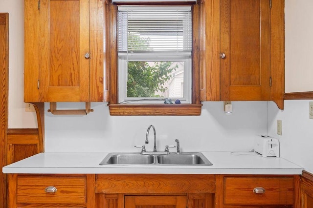 99 Hill St, Biddeford, ME 04005 - kitchen featuring light countertops and brown cabinetry
