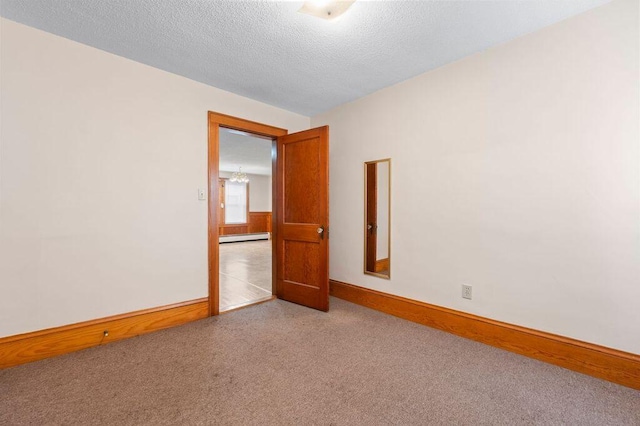99 Hill St, Biddeford, ME 04005 - carpeted spare room with a baseboard radiator and a textured ceiling