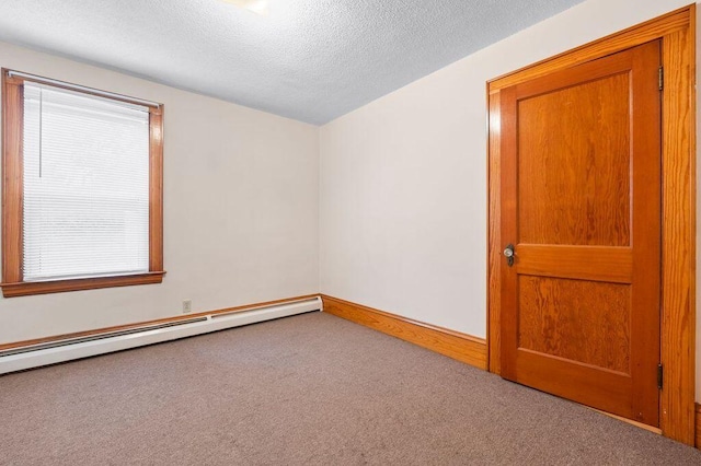 99 Hill St, Biddeford, ME 04005 - empty room featuring carpet, a baseboard radiator, and a textured ceiling