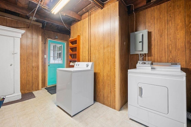 99 Hill St, Biddeford, ME 04005 - laundry area featuring wooden walls, separate washer and dryer, electric panel, and light flooring