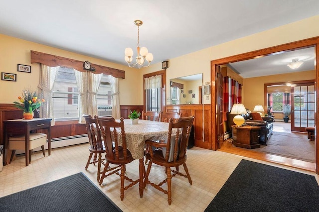 99 Hill St, Biddeford, ME 04005 - dining area with plenty of natural light, a wainscoted wall, and a chandelier
