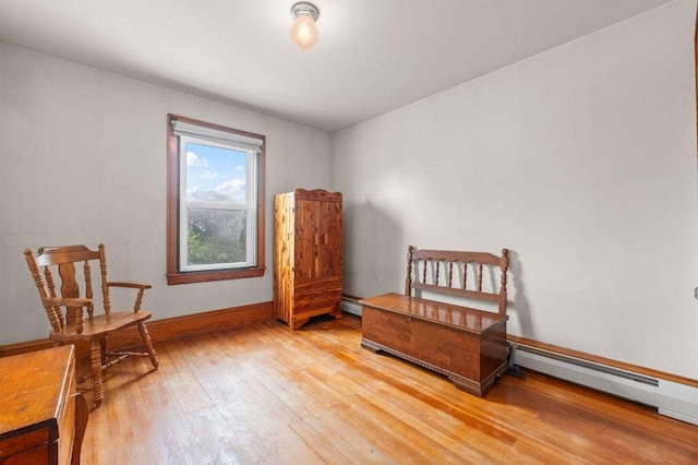 99 Hill St, Biddeford, ME 04005 - bedroom with light wood-type flooring and a baseboard heating unit
