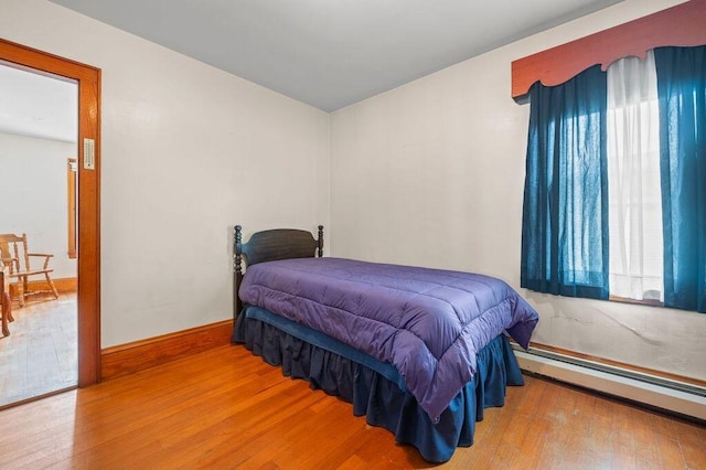 99 Hill St, Biddeford, ME 04005 - bedroom featuring wood finished floors and baseboard heating