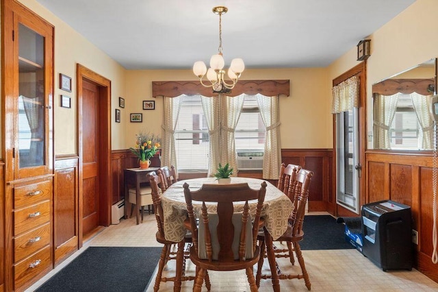 99 Hill St, Biddeford, ME 04005 - dining area featuring a wainscoted wall, a chandelier, baseboard heating, and cooling unit