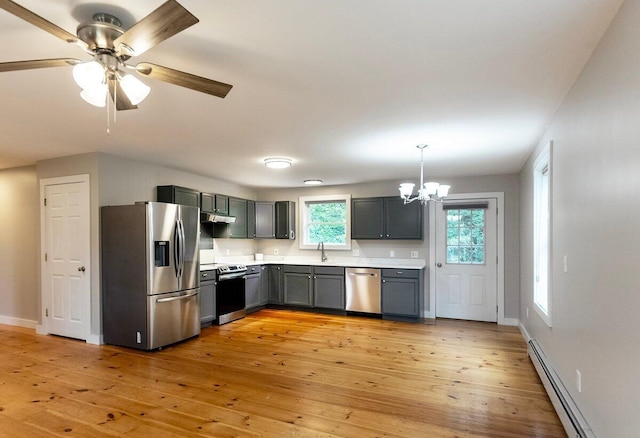 7 Lucas Ct, Bristol, ME 04539 - kitchen with appliances with stainless steel finishes, a chandelier, a baseboard heating unit, light countertops, and light wood-type flooring