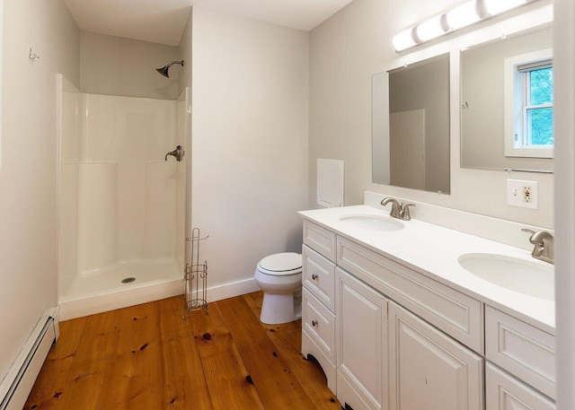 7 Lucas Ct, Bristol, ME 04539 - bathroom featuring a baseboard radiator, double vanity, a shower, and wood finished floors