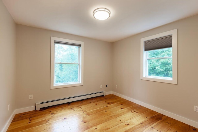 7 Lucas Ct, Bristol, ME 04539 - empty room featuring plenty of natural light, a baseboard radiator, and light wood-type flooring
