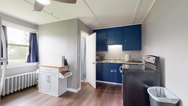 28 Stewart St, Lewiston, ME 04240 - kitchen featuring blue cabinets, electric range, dark wood finished floors, radiator heating unit, and a ceiling fan