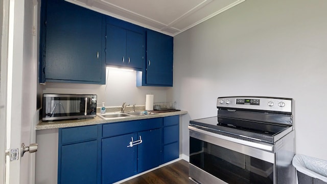 28 Stewart St, Lewiston, ME 04240 - kitchen featuring blue cabinets, stainless steel appliances, dark wood finished floors, and light countertops