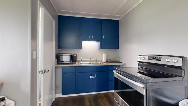 28 Stewart St, Lewiston, ME 04240 - kitchen with blue cabinetry, appliances with stainless steel finishes, light countertops, and dark wood-style flooring