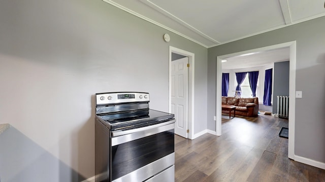 28 Stewart St, Lewiston, ME 04240 - kitchen featuring electric range, crown molding, dark wood-style flooring, and radiator heating unit