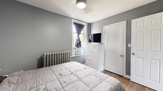 28 Stewart St, Lewiston, ME 04240 - bedroom featuring radiator heating unit, wood finished floors, ceiling fan, and cooling unit