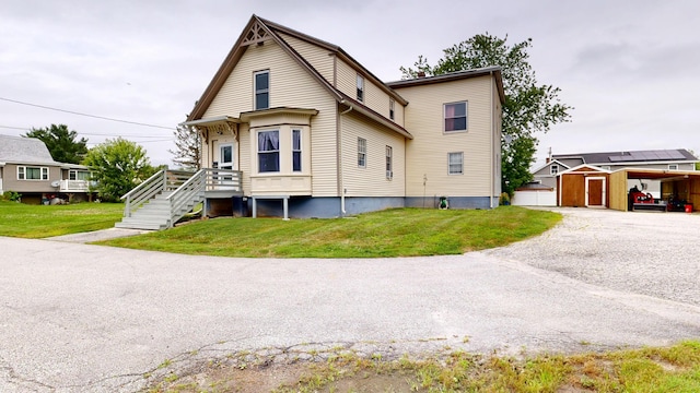 28 Stewart St, Lewiston, ME 04240 - view of front of property featuring an outdoor structure and a front lawn