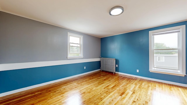 28 Stewart St, Lewiston, ME 04240 - unfurnished room with radiator, wood finished floors, and ornamental molding