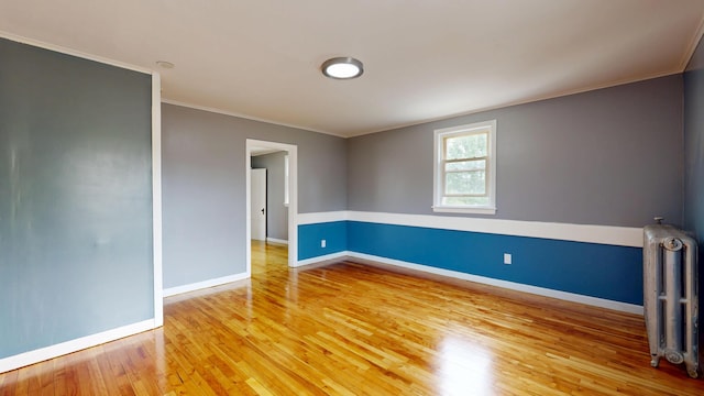 28 Stewart St, Lewiston, ME 04240 - empty room with radiator, crown molding, and light wood-type flooring