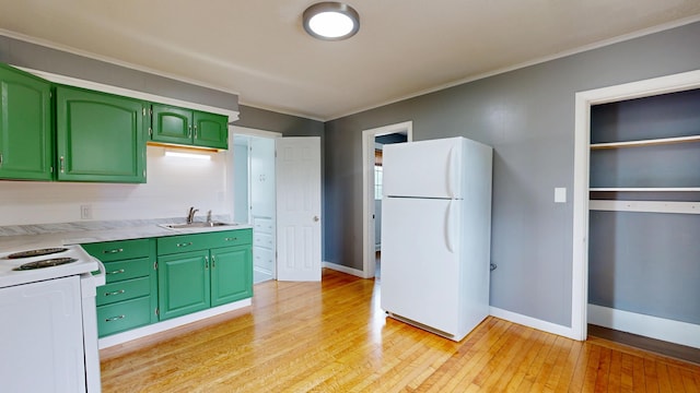 28 Stewart St, Lewiston, ME 04240 - kitchen featuring green cabinets, white appliances, light wood-style flooring, light countertops, and crown molding
